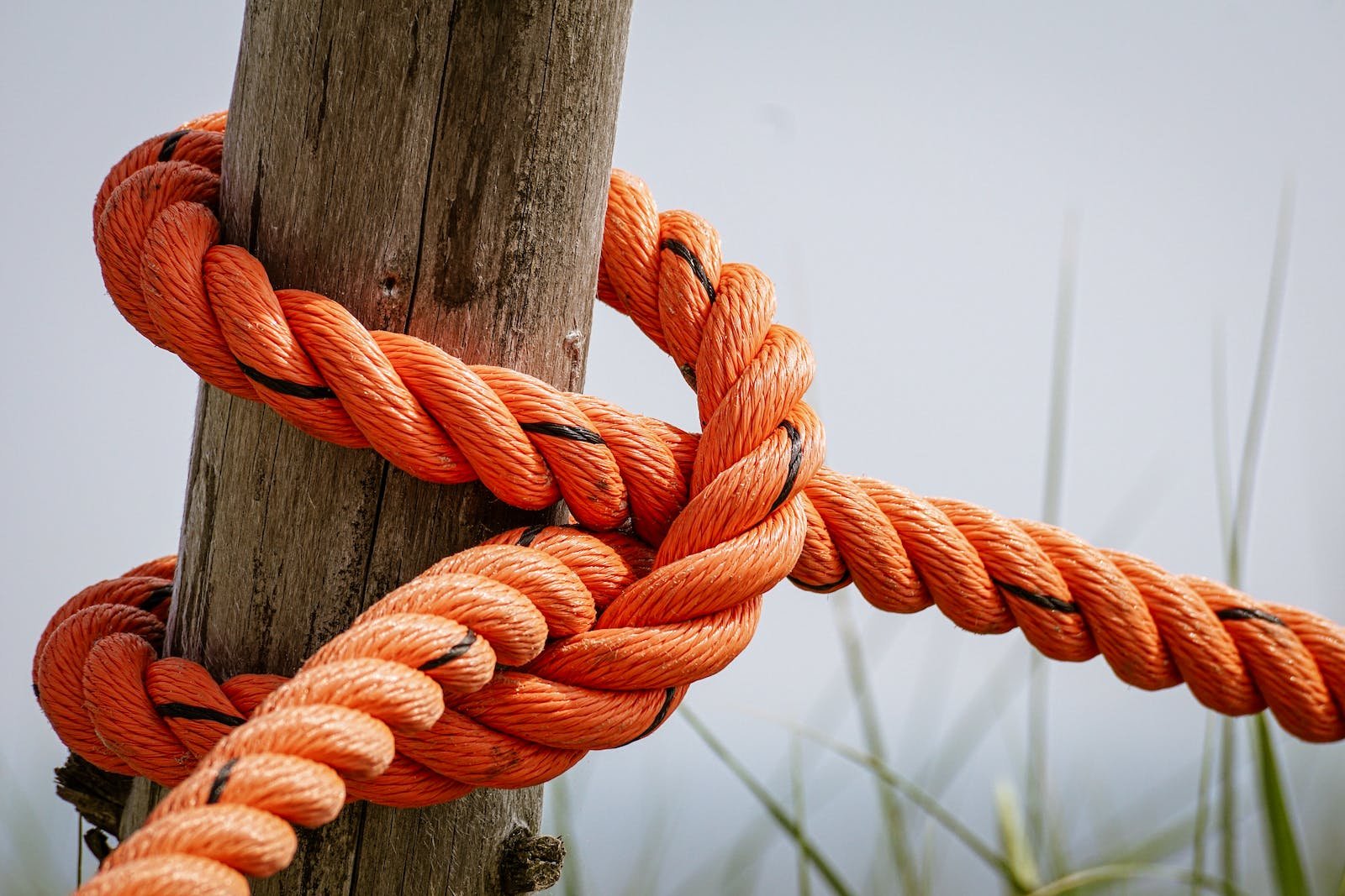 knot tied around wooden pole