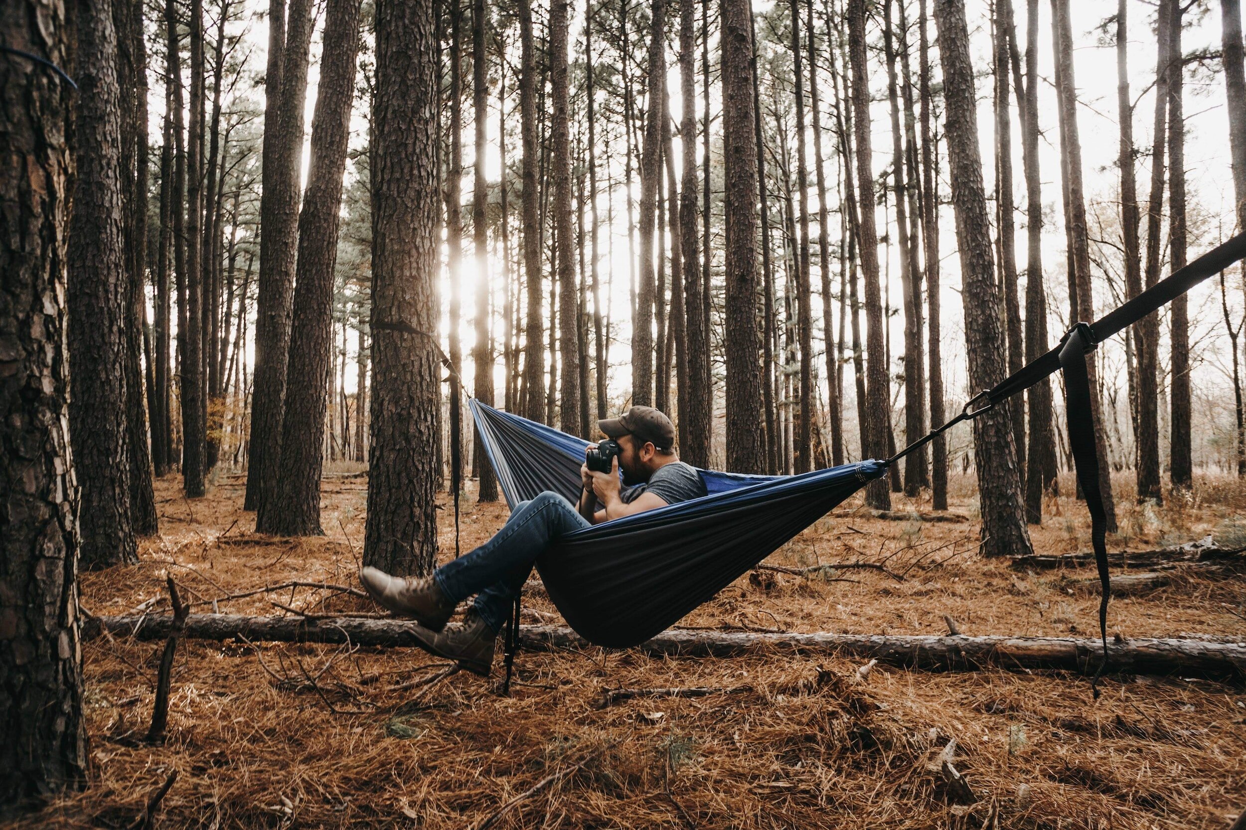 man taking a picture in a hammock