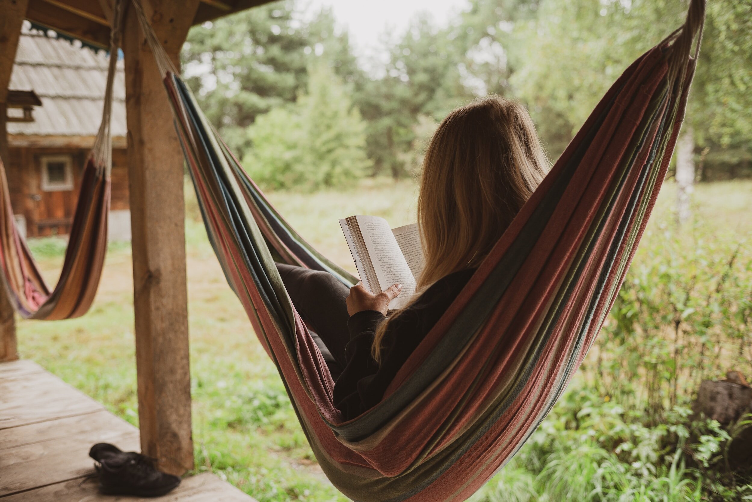 lady reading a book in a hammock